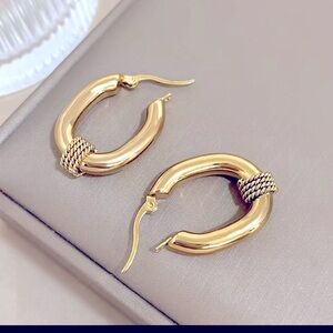 Unique gold hoop earrings with a little roped design.